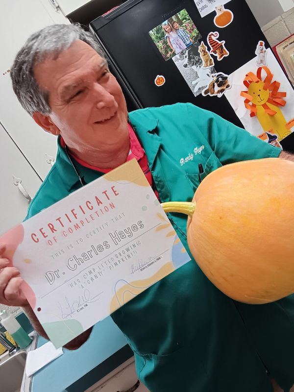 carousal-img9 Dr. Charles Hayes holding a certificate